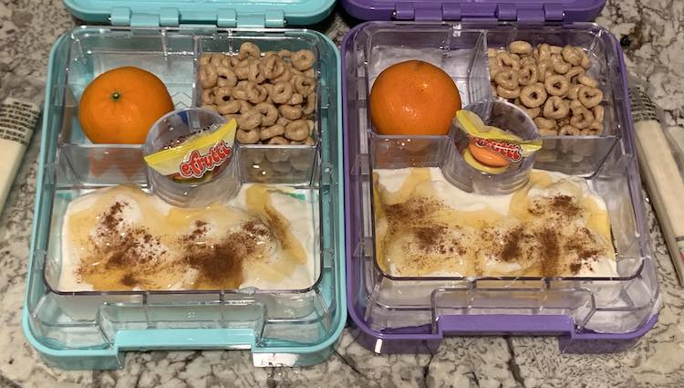 Used their new snack-sized bento boxes to make a yogurt parfait. Both opened boxes are next to each other filled up with a simple and easy lunch.