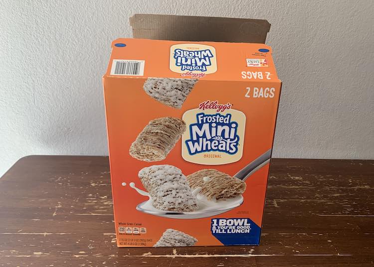 View of the large, double, cereal box emptied and open at the top. 