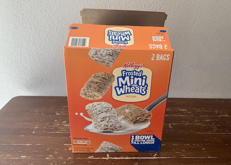 View of the large, double, cereal box emptied and open at the top.