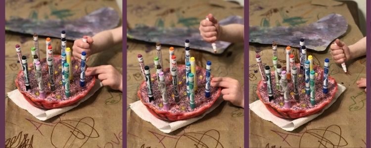 Collage of three views of the felt pen holder as Ada reaches out and grasps the marker (left), pulls it out (center), and draws next to the holder (right). 
