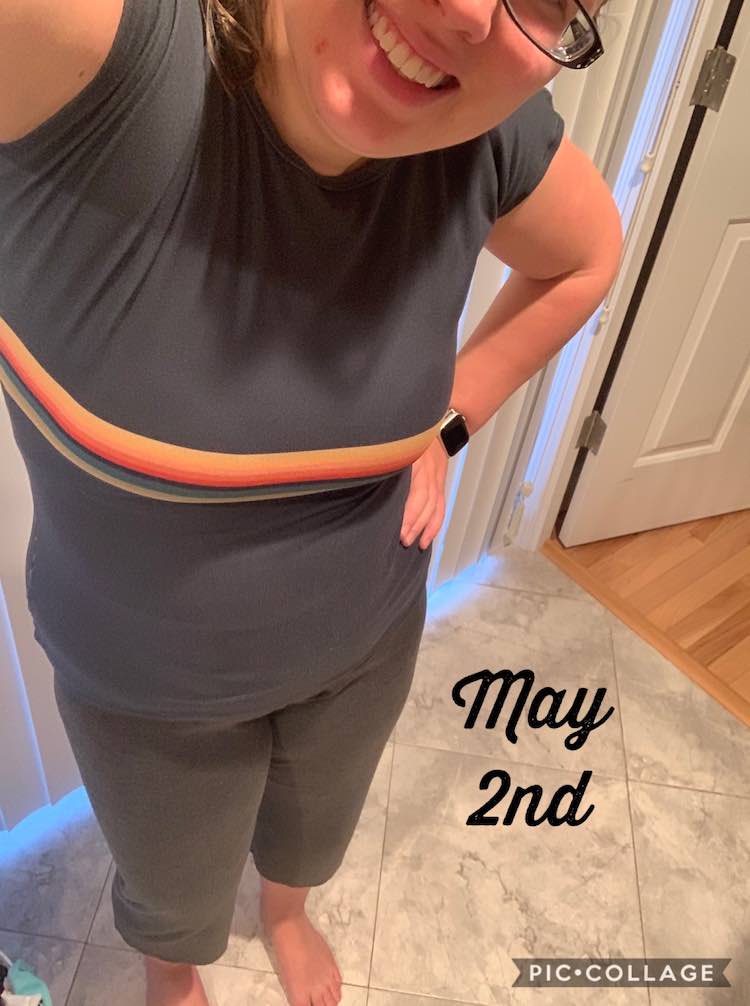 Me standing, with my head tilted to fit partially in the photo, in front of our blinds. I'm wearing a blue tshirt with stripes across my breast and grey capris. Beside me is black font saying 'May 2nd'.