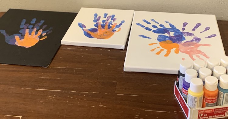 The canvases are placed side-by-side with the small one in the center and the larger ones on either side. In the foreground you can see the pack of acrylic paint I used.