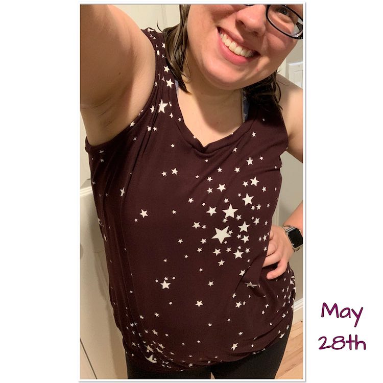 Yet another selfie of my head tilted and hand on my hip. The focus of the photo is sleeveless purple-y top with white stars spaced in clusters.