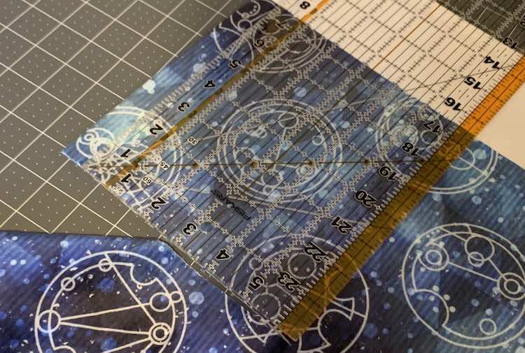 Image showing the corner of the coordinating double plush fabric on a cutting mat with a quilting ruler measuring 7.5 inches from white edge to cut mark. 