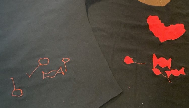 Image shows the front of the shirt, right side up on the right side of the photo, and the back side of the shirt, wrong side up on the left so you can see the difference between the front (red shapes) and back (thread outlines) of the fabric. 