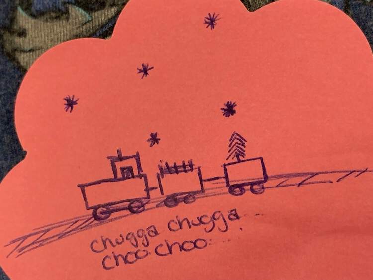 Image shows part of a pink flowered post-it note with a blue inked train on tracks saying 'chug chug Choo Choo' underneath and snowflakes above. 