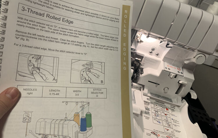 Image shows most of the 3-Thread Rolled Edge page in the baby lock instruction book as the serger, behind it, is opened up.