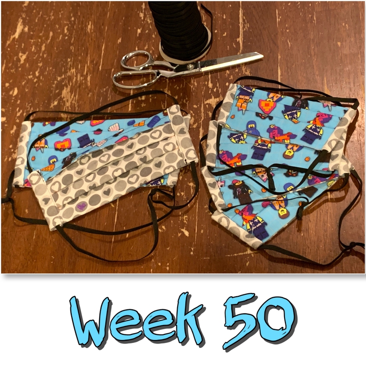Image shows six finished LEGO masks with black elastic behind it and a pair of scissors. Underneath it says "Week 50" in black outlined turquoise. 