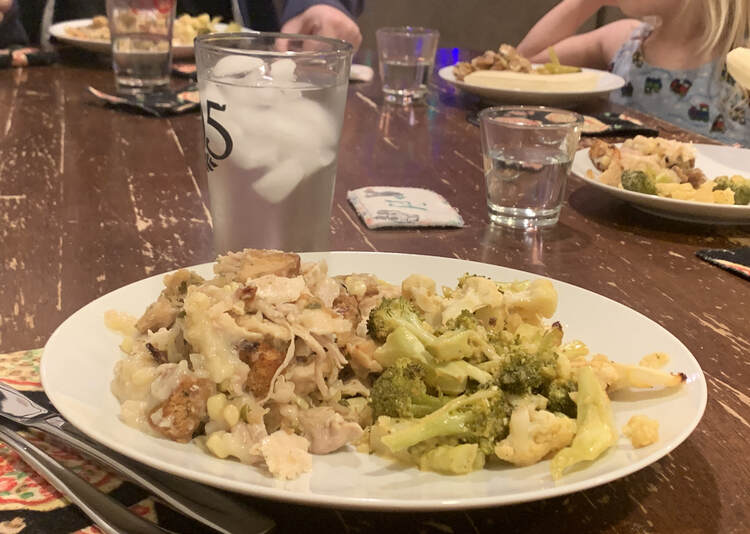 Image shows a white plate half filled with the vegetable mix and the other half a turkey and potato based casserole. In the background you can see the kids and Matt's plates and the water glasses.