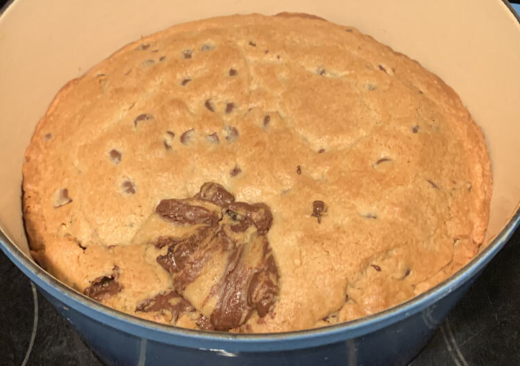 Image shows a cookie filling the bottom of my blue Dutch oven. 