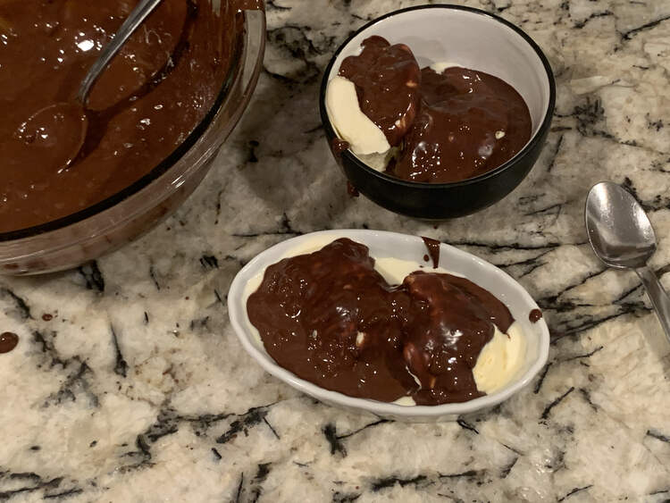 Image shows a large glass bowl containing the homemade chocolate shell and a metal spoon. Beside it sits two smaller dishes each with two scoops of vanilla ice cream covered in a layer of chocolate.