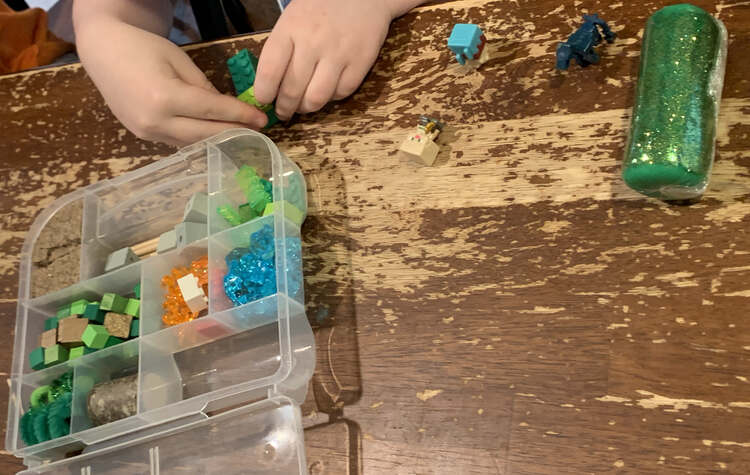 Image shows a Minecraft themed sensory kit with lots of greens, reds, and blues.