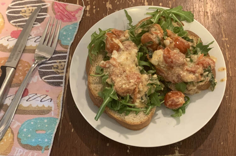 Image shows the same toast as before although it's now been coated with the white and red baked mixture so you can't see the balsamic and most of the arugula is covered up. 