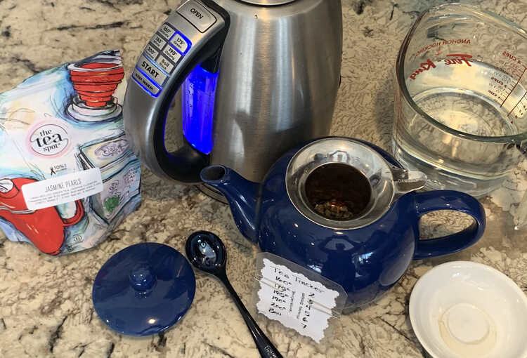 Image shows Jasmine Pearls set in the teapot with the electric kettle heating to 175° and a tea tracker set to the proper temperature and three minutes of steep time. 