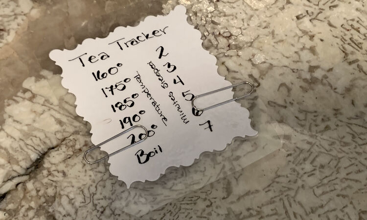 Image shows the Tea Tracker laid out on my kitchen counter with the paper clips showing 200 degrees and 6 minutes. Above the left paper clip you can see a mark between the 185 and 190 degrees showing where it was before. 