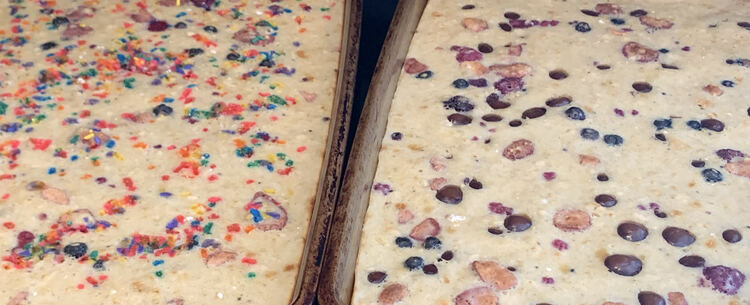 Same image as before but the pancakes are baked so the sprinkles have sunk in a bit and melted into colored blobs (left) while the chocolate covered acai have sunken and stayed visible. 