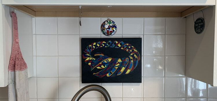 Further away view of the same painting but now you can see the towel hung up on the command hook to the left and some other hanging items.