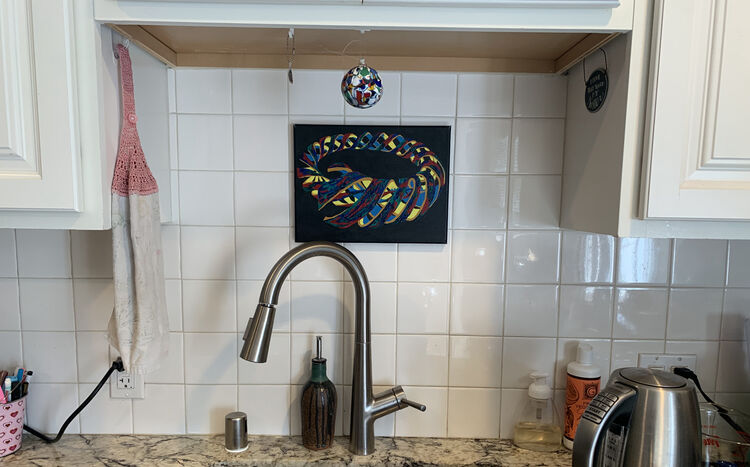 The same photo but zoomed out a bit more to see the faucet, kettle, and other counter things.