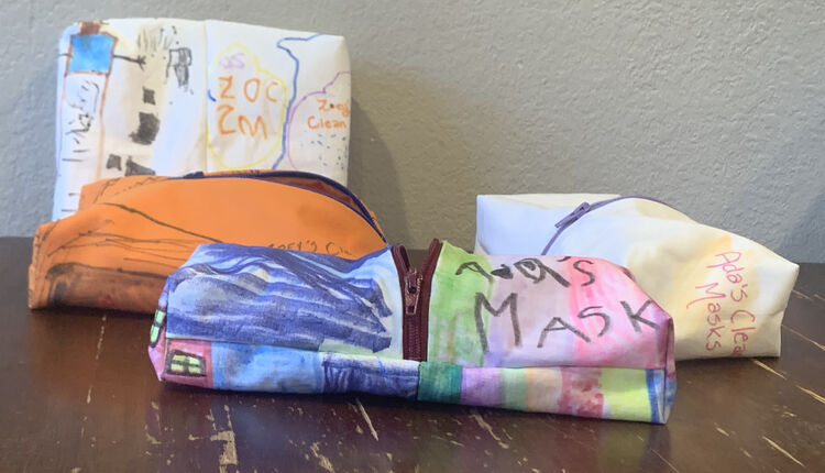 Image shows four colorful zippered pouches laid out on a table. 