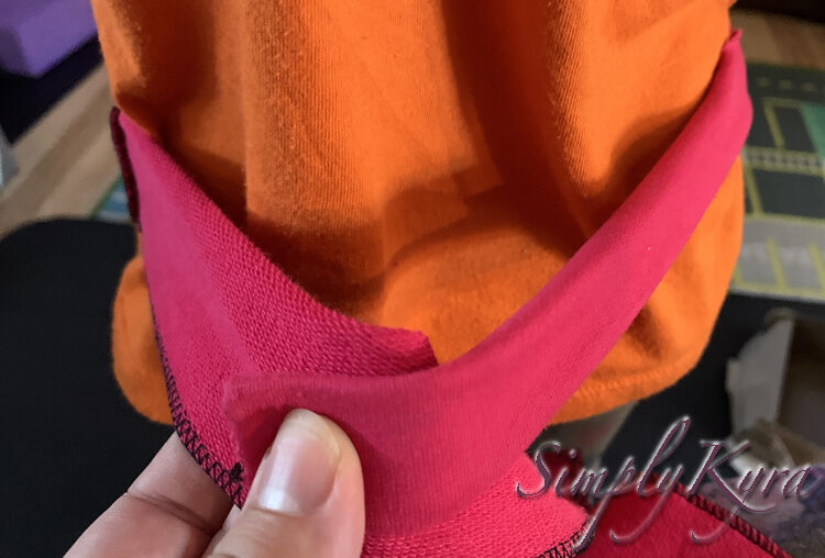 Image shows the flat pink strip wrapped around Zoey's waist with the ends overlapped so I know where to trim it.  