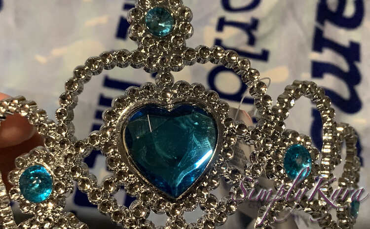 Image shows a closeup of the heart jewel on the cheap silver crown. 