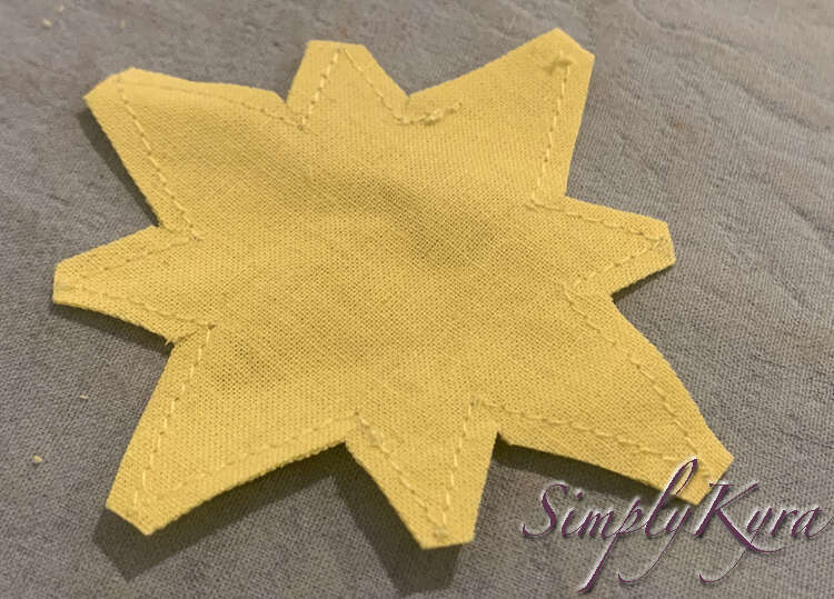 Image shows the yellow star with only a thin seam allowance along each edge. 