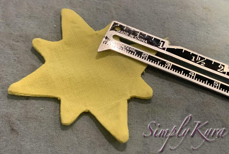 Image again shows the yellow star but this time the ruler has shifted to highlight the one inch space between the right side point and the point a bit above it. 
