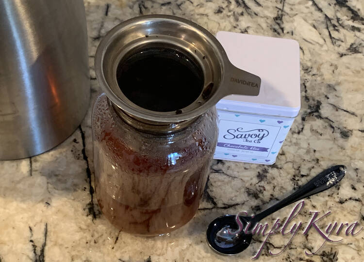 Image shows the infuser filled up to the top with water. The jar is only halfway, or less, filled and you can see water on the counter under it. 