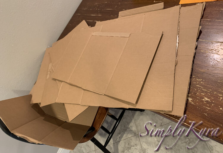 Image shows a stack of flat cardboard boxes. 