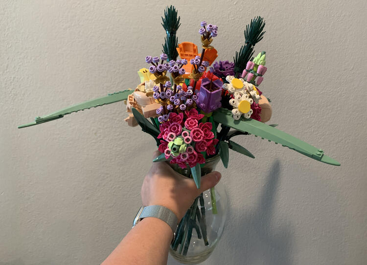 Image is taken looking at the clear vase containing all the blooms from all three kits. You can see my hand holding the vase and the stems inside the clear vase along with all the blooms together. 