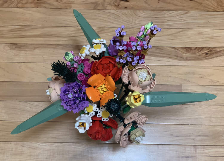 Image is taken from above looking down at the full bouquet set on a wooden floor. 