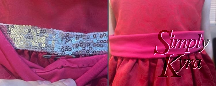Image is a collage of two images. The one on the left shows the safety pin attaching the dress right under the silver to the bottom of the pink sash. The sash is folded down to better show how it works. 