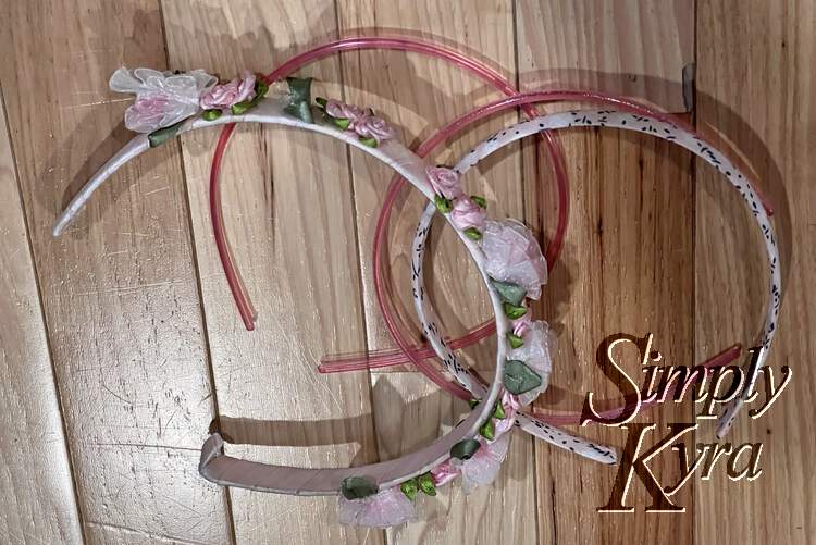 Image shows found pink headbands laid out on the floor.