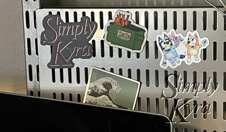 Image shows all four magnets attached to the metal pinboard above my laptop screen. 