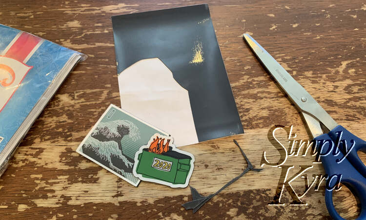 Image shows the two stickers with the magnetic backing trimmed away so you can't tell they’re magnets. In the background is the rest of the magnet sheet, scissors, packaging, and magnetic pieces.