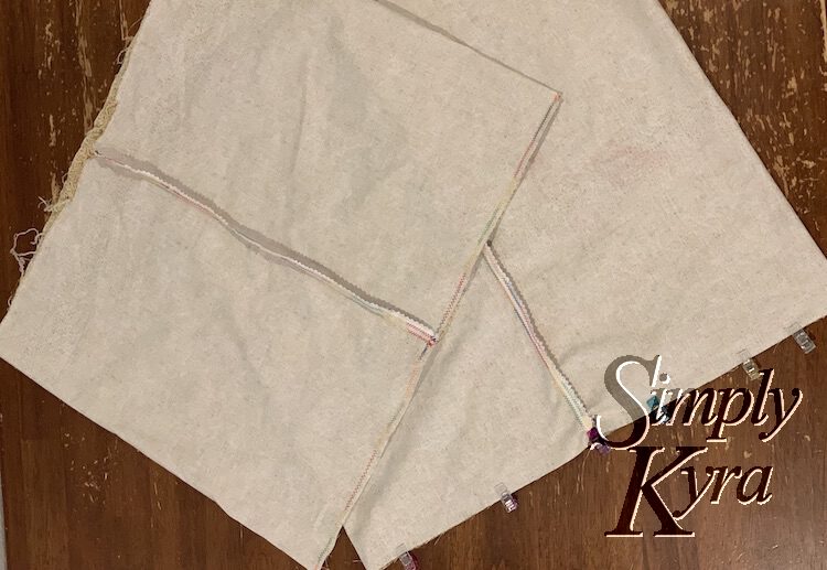 Image shows two inside out bags with the seam along the center front. The bag on top has the bottom seam sewn while the bag underneath is clipped along the bottom place.