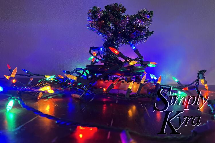 The bonsai surrounded with Christmas lights taken from the base looking up. 