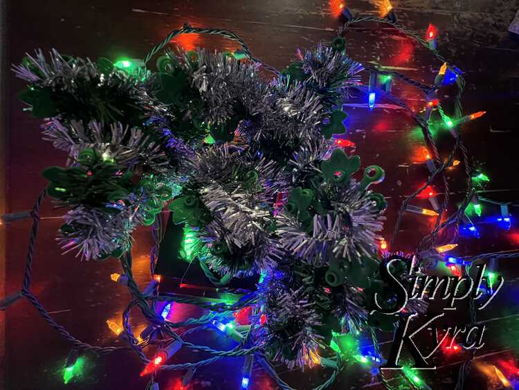 Image shows a closeup view of the bonsai from above with the lights surrounding the base below. 