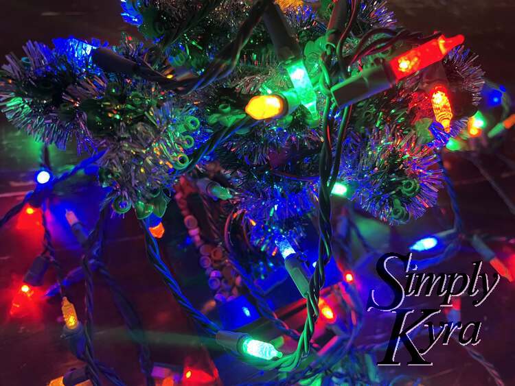 A side view looking down at the tree with the lights draped over top.