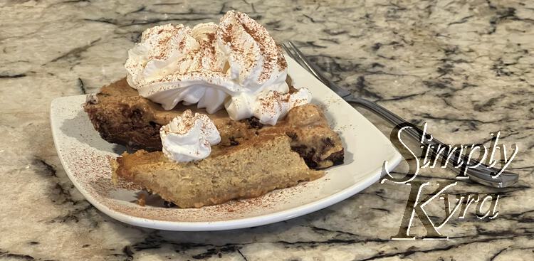 Image shows the two pieces of pie side by side on a square white saucer on a counter beside a fork. The original one is in the front and is much smaller than the larger piece in the back. Both are topped with whip cream and sprinkled with cinnamon. 