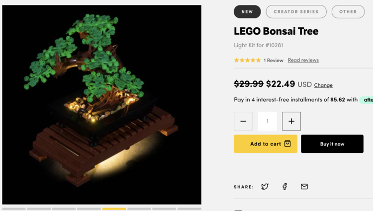 Screenshot shows the lit up bonsai on the left one a black background. The light comes from below and the rocks surrounding the tree. On the right you can see their main listing information. 