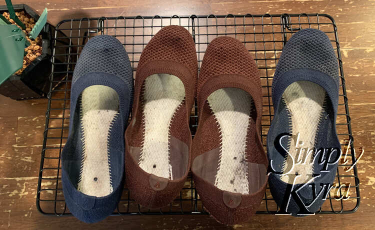 Image shows both pairs of flats laid out in a row on a cooling rack on the kitchen table beside a LEGO planter. 