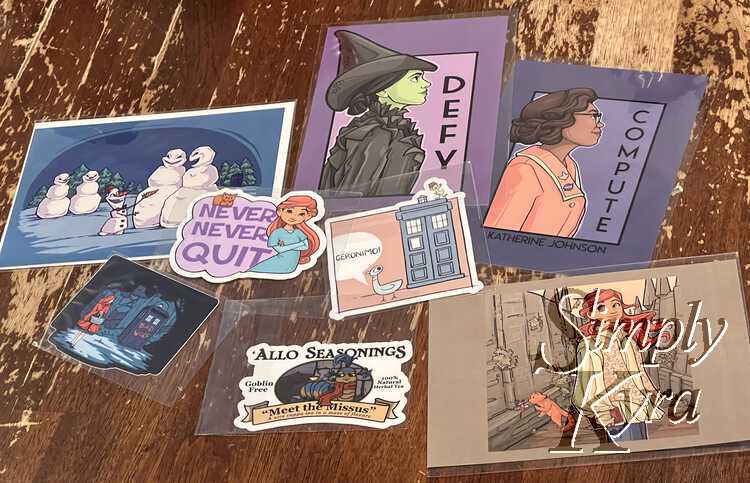Image shows the postcards (Defy, Compute, and 13th) along the right side of the image. The Olaf Doctor Who snowmen notecard is to the left. At the bottom left are the three stickers I bought including "Never Never Quit", Bad Wolf, Mo Willems -esque, and one labeled "'Allo Seasonings" from Labyrinth.