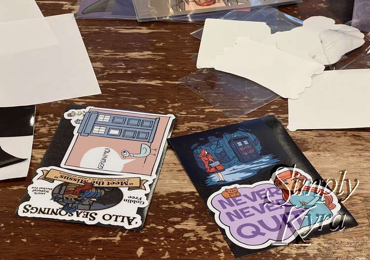 Image shows two magnetic sheets side by side covered with stickers. The magnetic sheet backing and sticker backing lays off to the side in the background. The left sticker sheet shows the labyrinth-inspired sticker and the Mo Willems' one slightly overlapping.