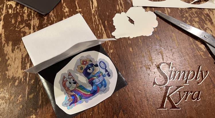 Image shows the magnetic sheet with the paper backing half off and sticking up. Underneath it is the circular cardstock and sticker.