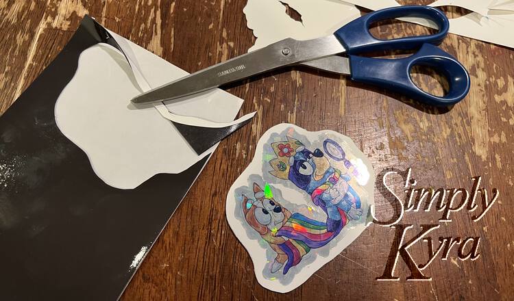 Image shows the final magnet laid out beside the rest of the magnetic sheet, paper, sticker backing, and scissors. 