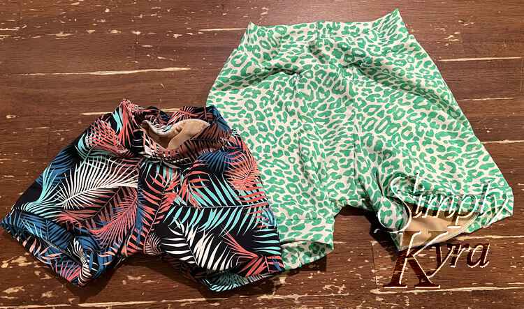 The two new swim bottoms matching their corresponding top with lining showing through the openings. 