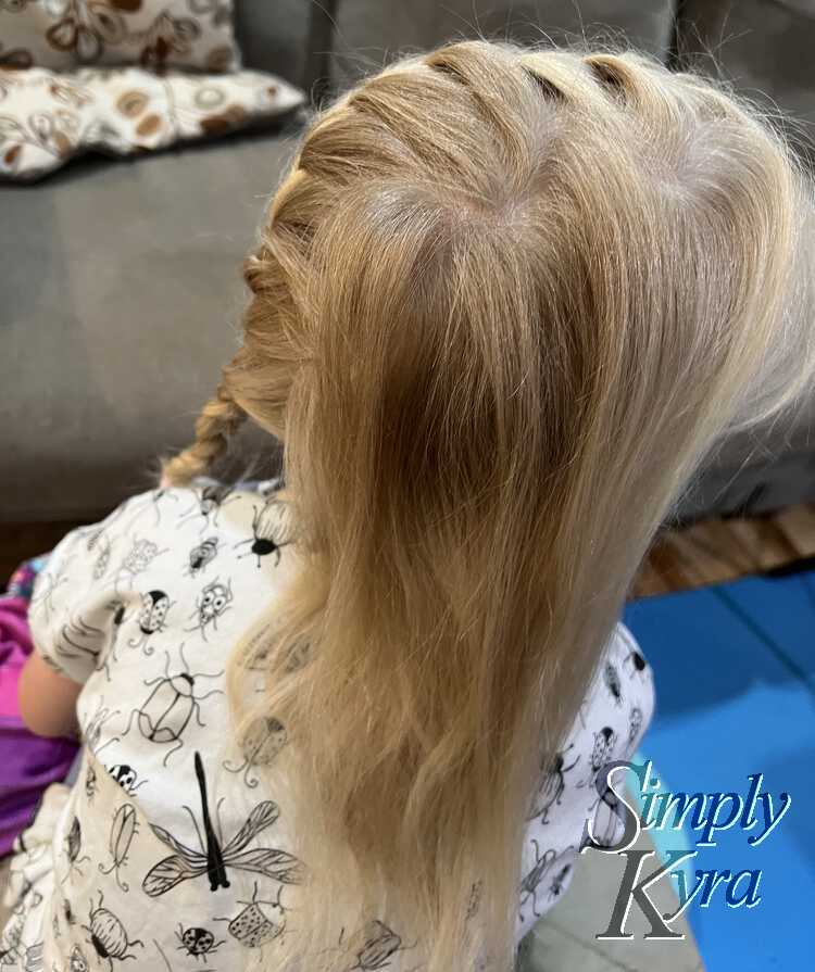 Image is taken from above and to the side so Zoey's loose hair is towards the camera as she looks to the right. You can see the zigzag and the braid on the backside. 