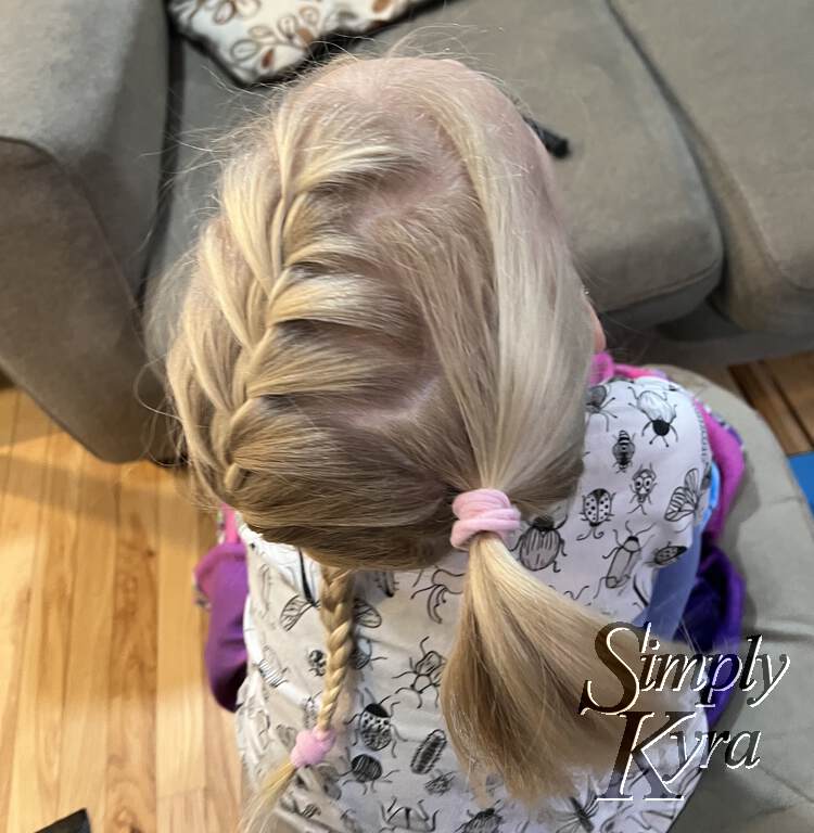 Top view of the finished hairstyle. Zoey's looking up and the photo is taken from the back.