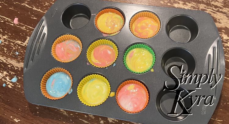 Image shows the colorful angel food cake splattered cupcake tin with so many different colors showing.